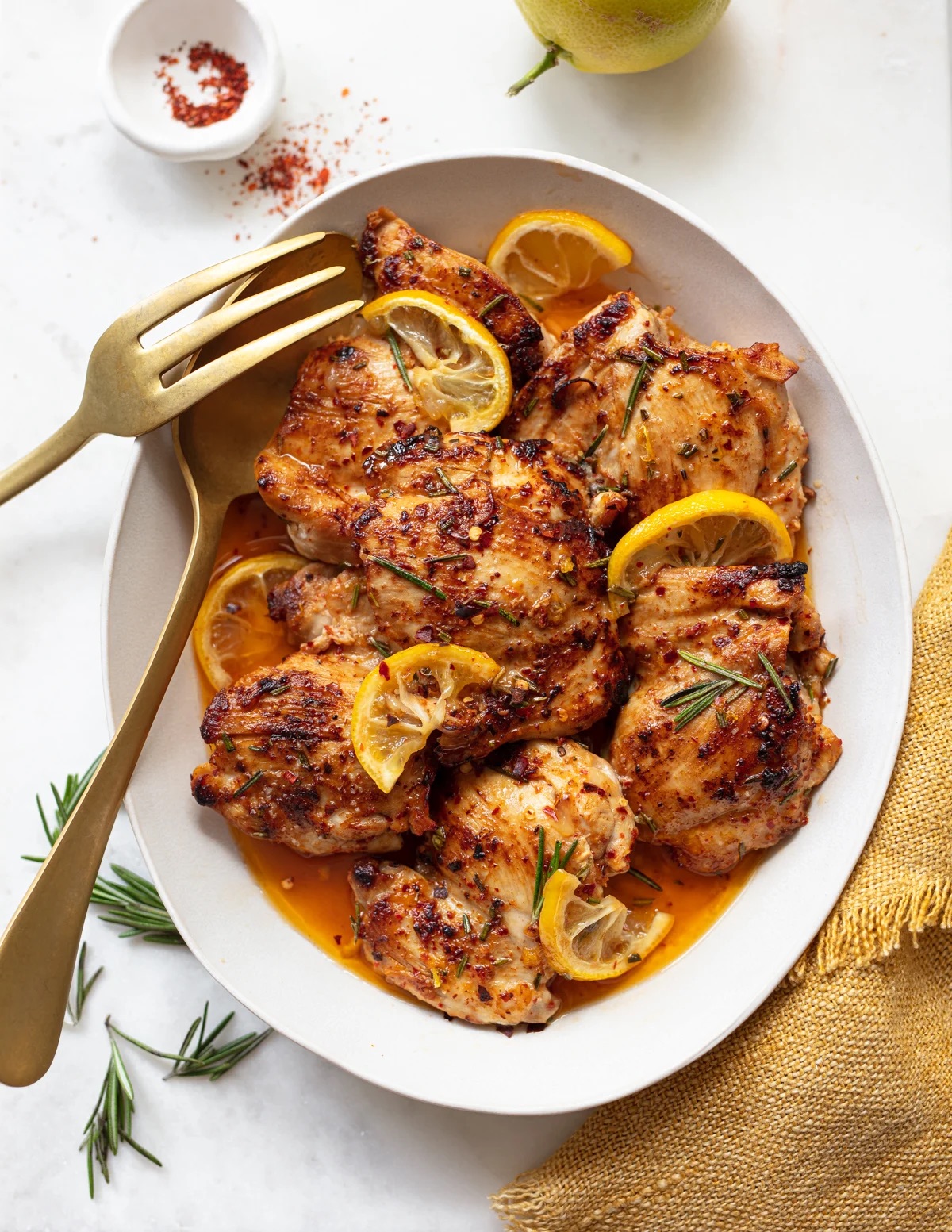 Lemon Herb Roasted Chicken Thighs • 27g Protein • Tender skinless chicken thighs roasted with fresh lemon, garlic & herbs.